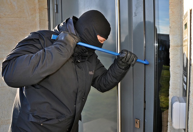 burglar breaking and entering with crowbar